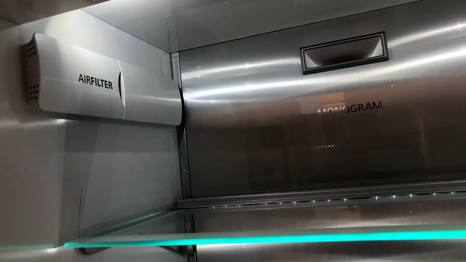 Inside a GE Monogram refrigerator: stainless steel interior, air filter and lit glass shelf